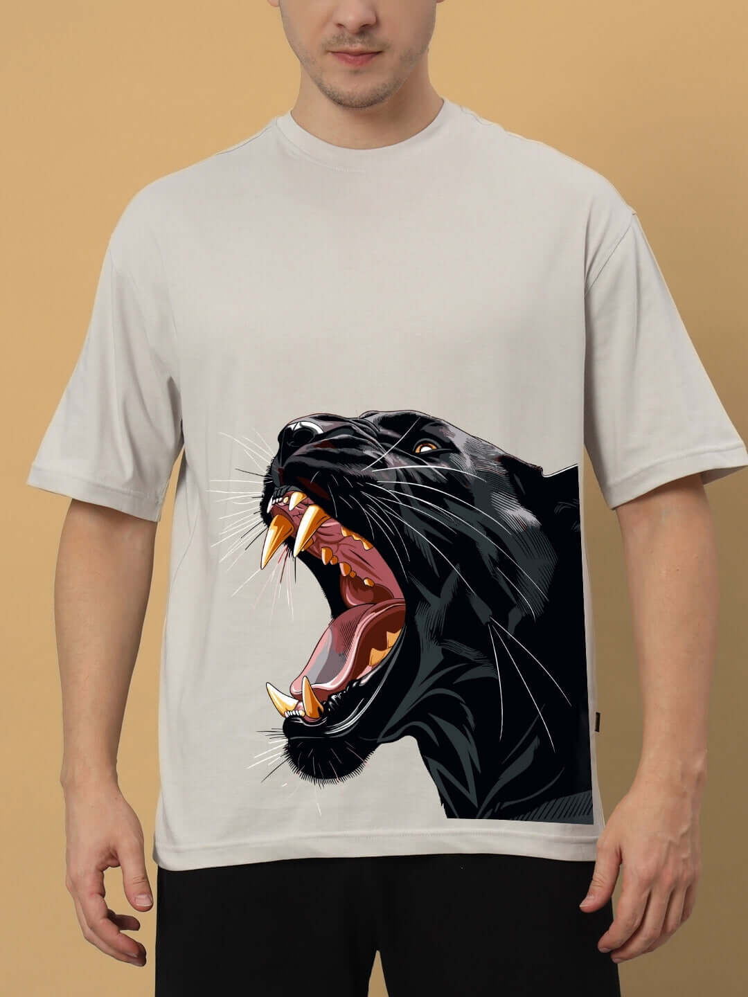 Man wearing ROAR AGAIN PRINTED OVERSIZED T-SHIRT GREY with panther graphic