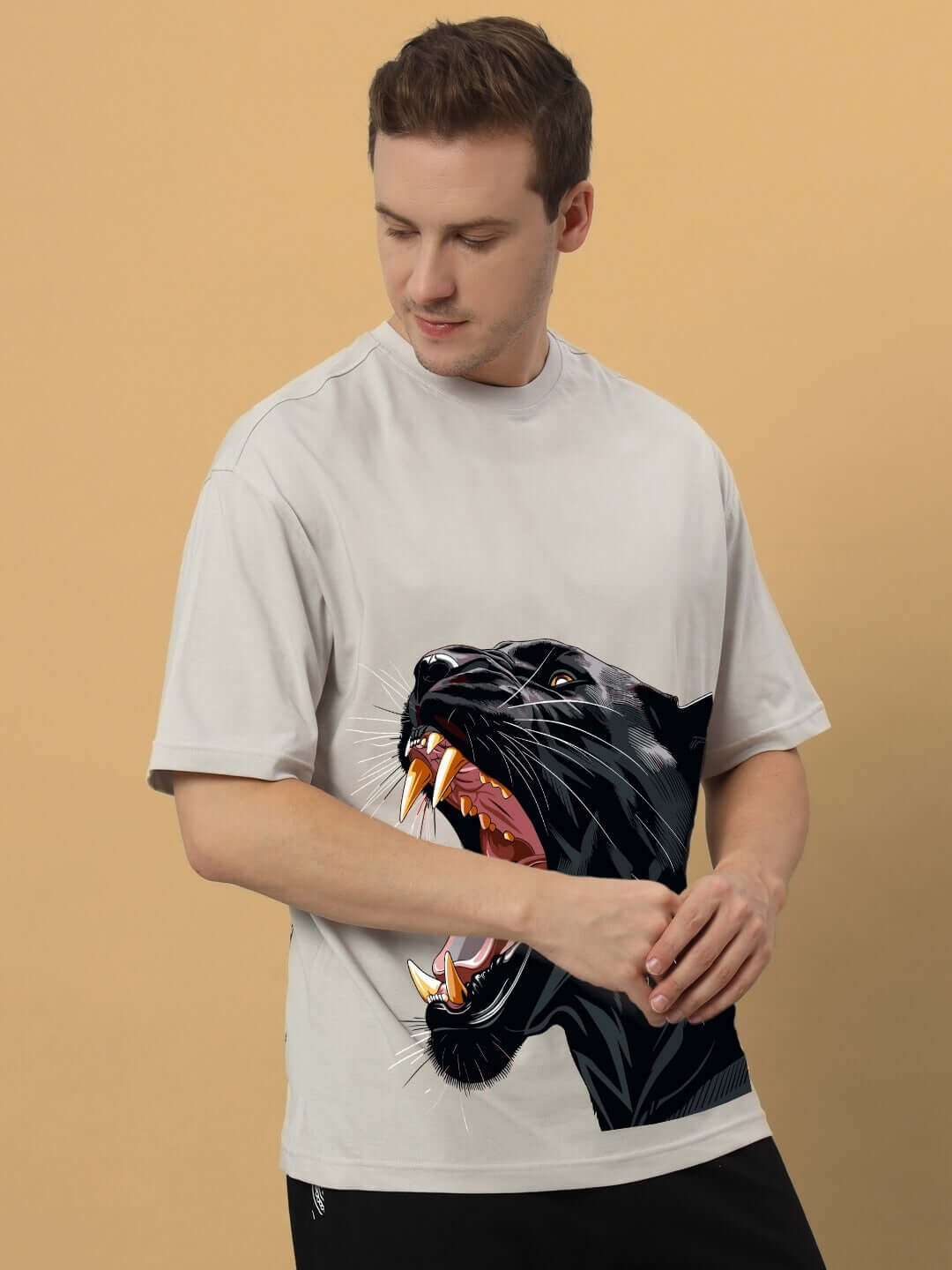 Man wearing ROAR AGAIN PRINTED OVERSIZED T-SHIRT GREY with bold graphic design.
