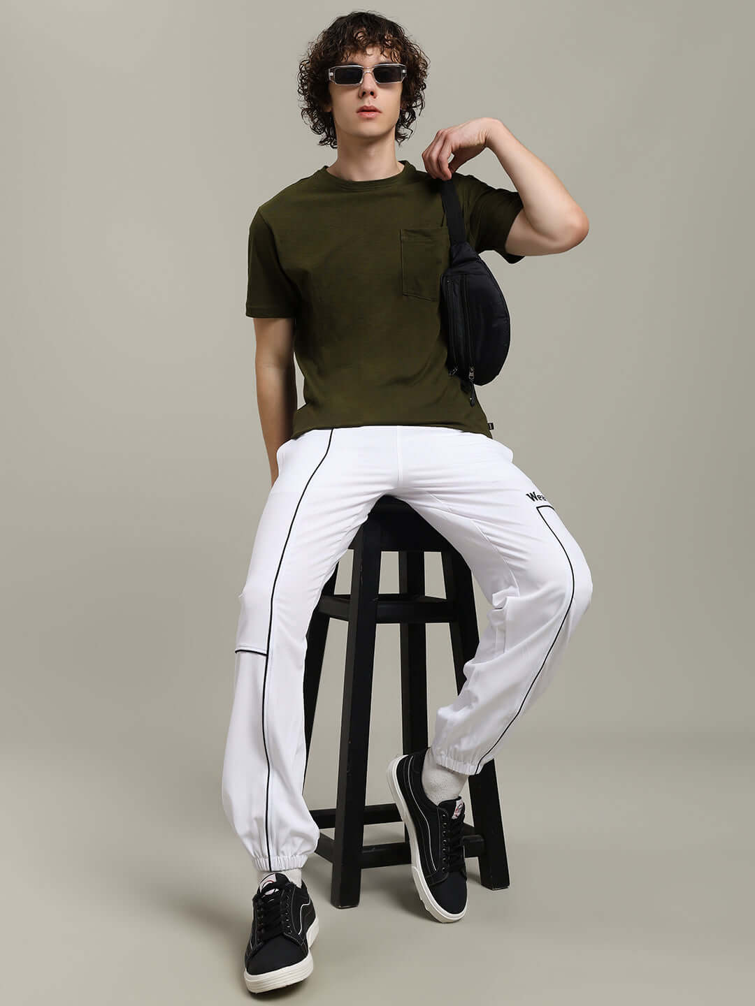Model wearing ROBAR olive regular fit t-shirt with white pants, showcasing premium heavy cotton slub fabric, styled casually.