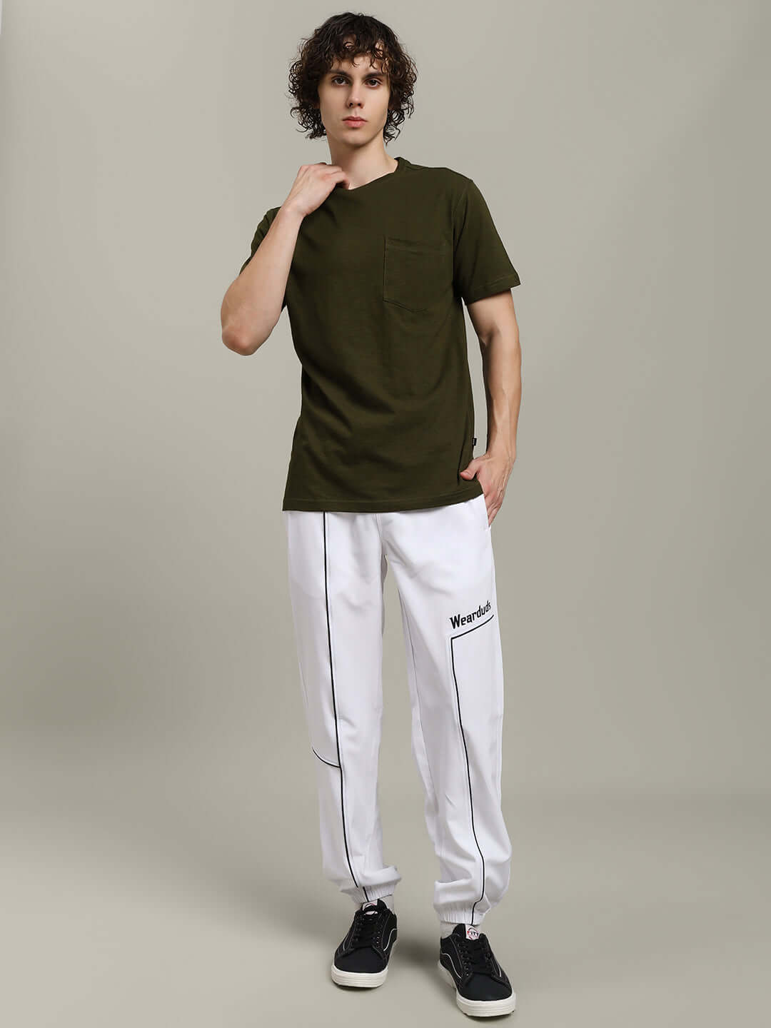 Model wearing ROBAR Regular Fit Olive T-Shirt made from premium heavy cotton slub fabric, styled with white pants and black sneakers.