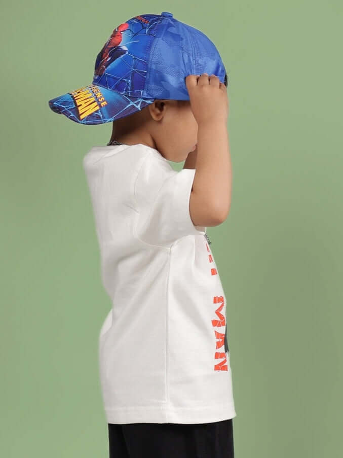 Child wearing Robin T-Shirt for Boys Girls Off White, side view, casual outfit, blue cap, green background, comfortable cotton fabric.