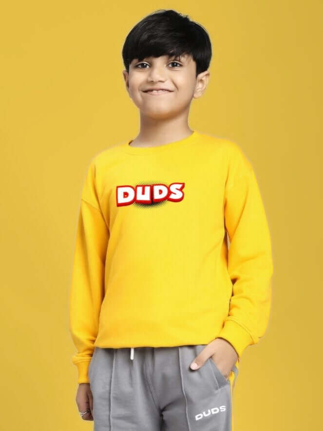 ROBLOX SWEATSHIRT FOR BOYS AND GIRLS YELLOW worn by a happy kid on yellow background