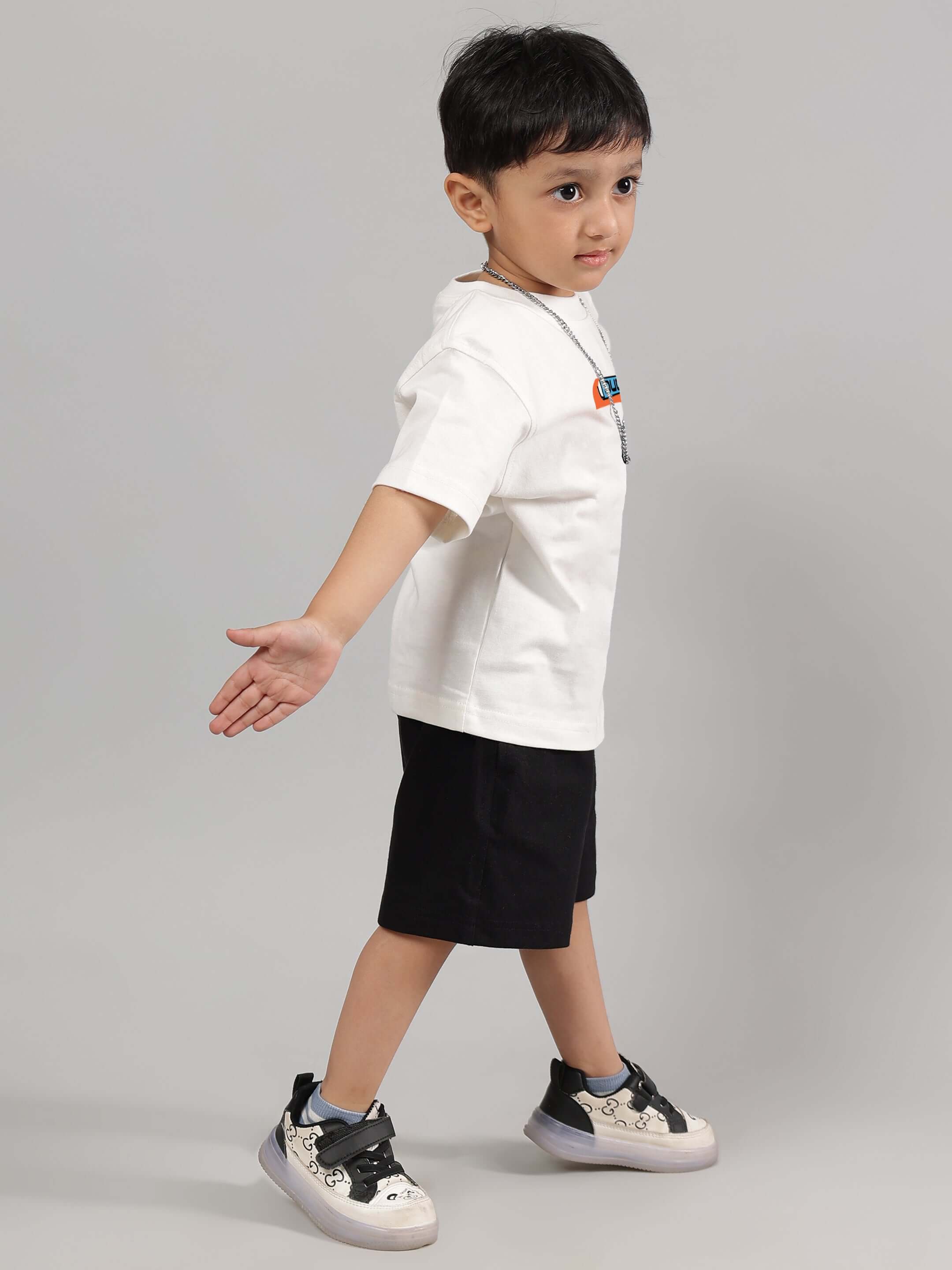 Child wearing ROBO SHARK CO-ORD FOR BOYS GIRLS WHITE-BLACK outfit, showcasing stylish kids' streetwear fashion with bold graphics.