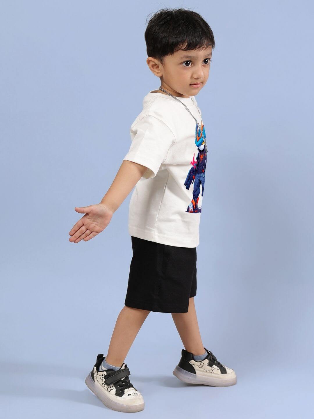 Child wearing Robo Super Co-ord Set in off white and black, featuring a vibrant printed T-shirt and classic black shorts.