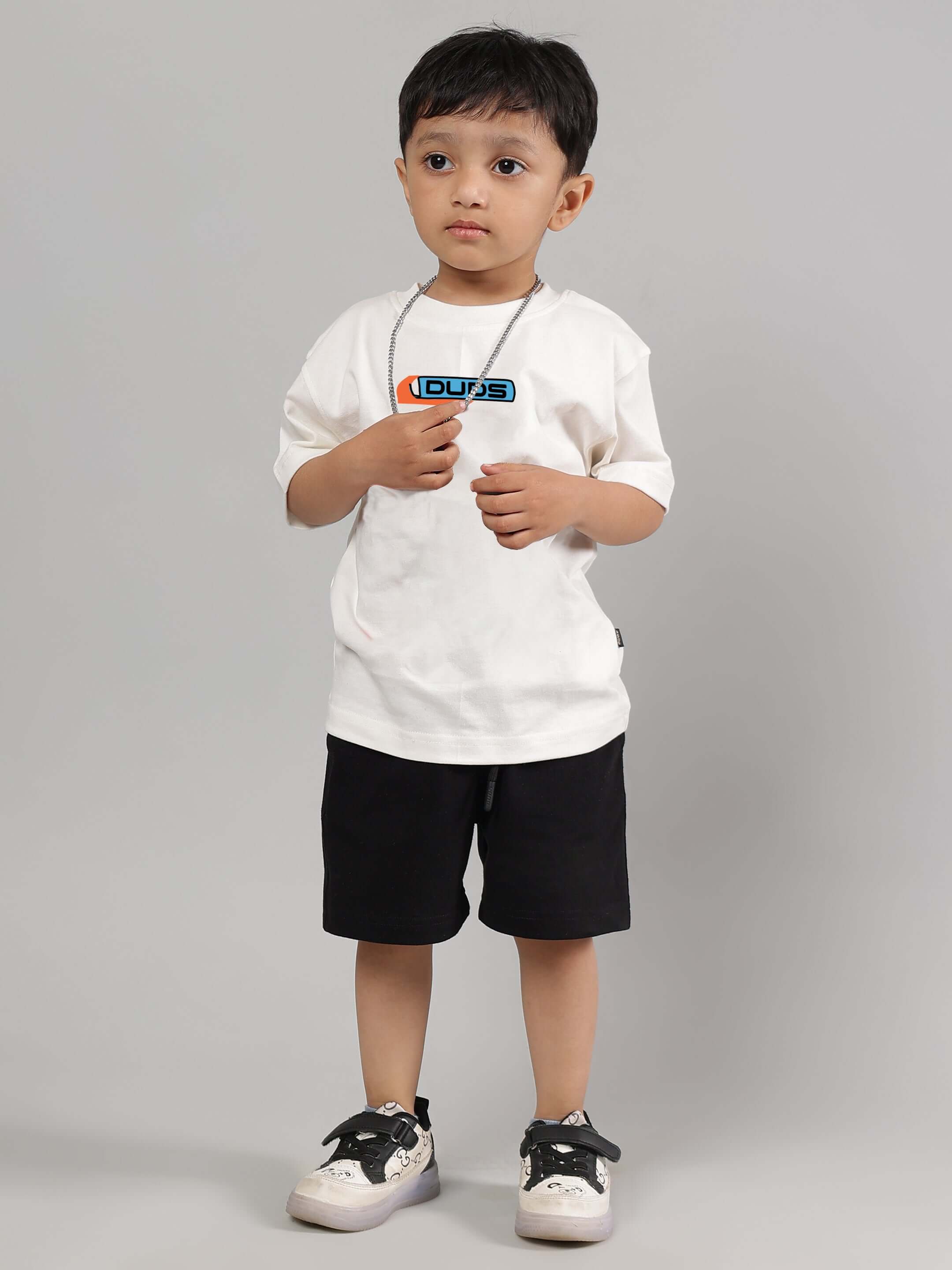 Child wearing ROBO SHARK CO-ORD FOR BOYS GIRLS WHITE-BLACK with white top and black shorts, stylish and playful streetwear outfit for kids.