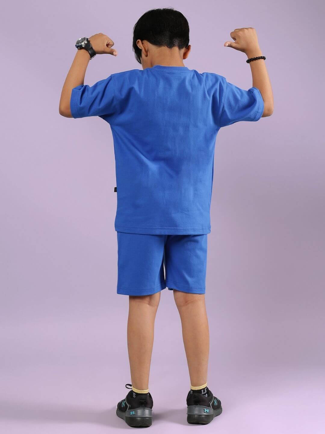 Child wearing blue Robo Super Co-ord Set with oversized T-shirt and shorts, showcasing trendy and comfortable fashion for boys and girls.
