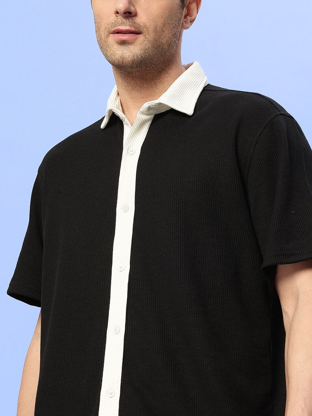 Model wears Robson Co-Ord Set in black waffle fabric, 100% cotton, half sleeves, relaxed fit, size large, highlighting contrasting buttons.
