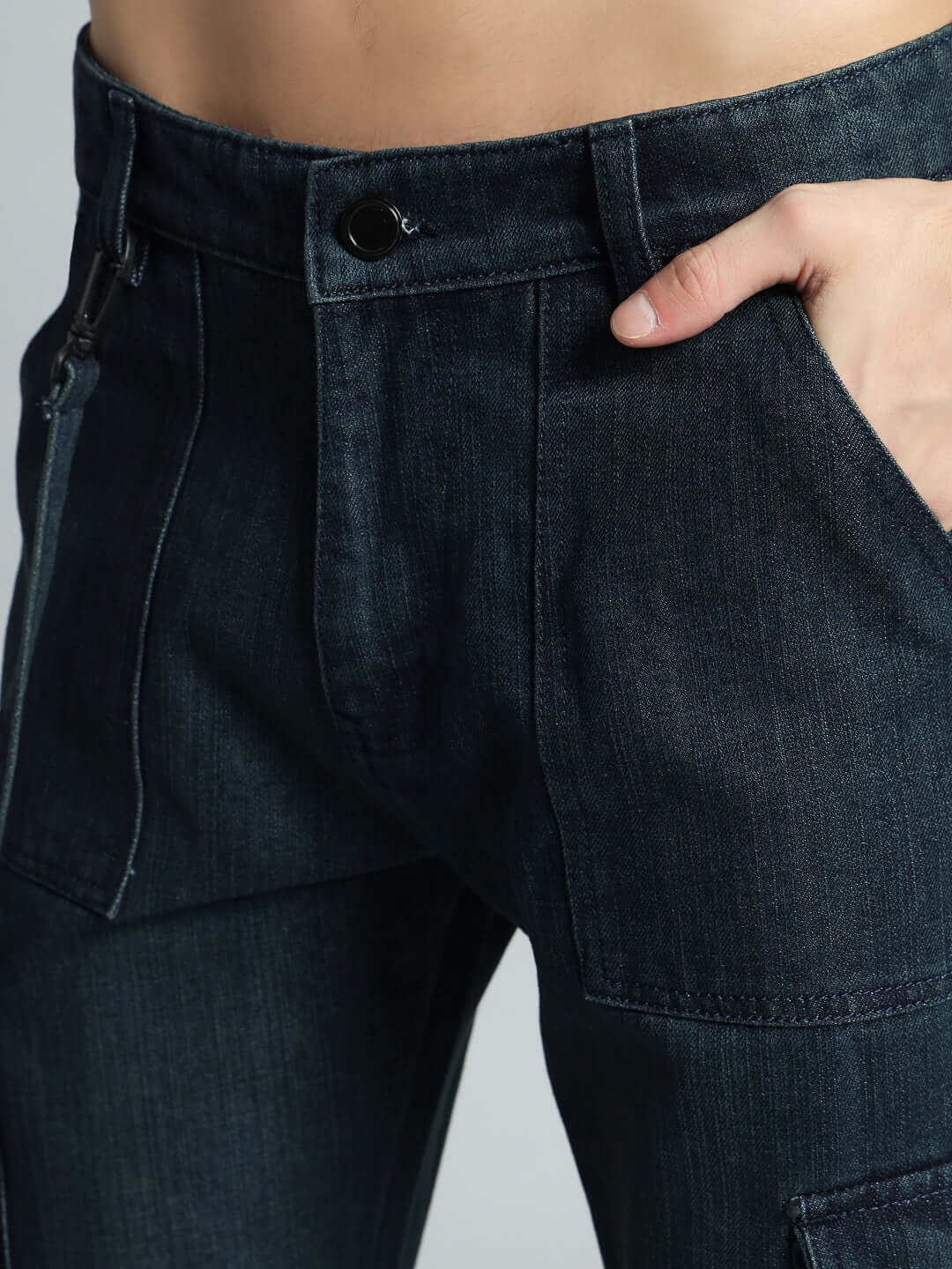 Close-up of Rockie Relaxed Denim Cargo in blue, showcasing deep front pockets and button closure, tailored by DUDS.
