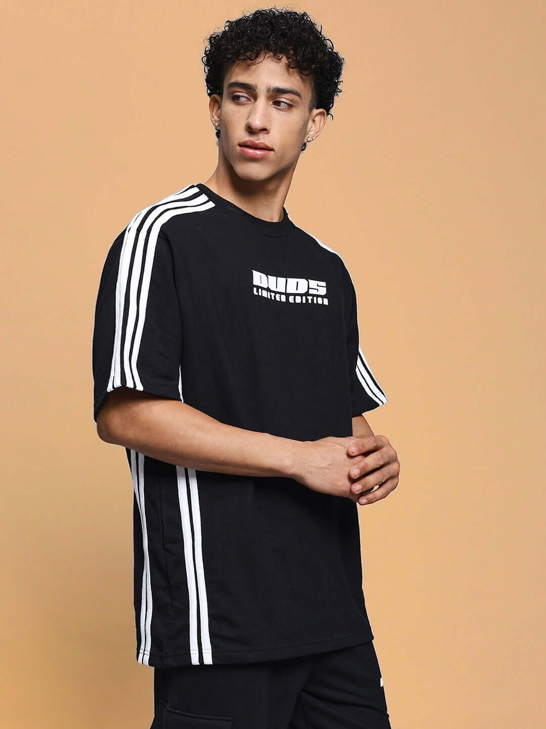 Man wearing a RODDY OVER-SIZED CLASSIC T-SHIRT BLACK with stripe details.