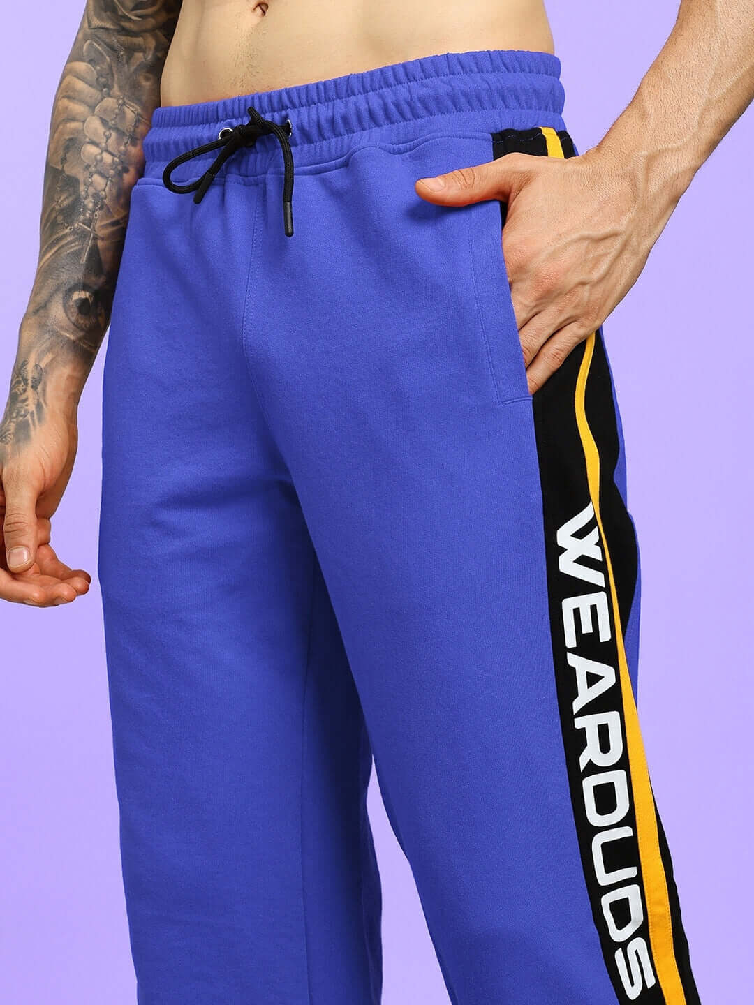 Close-up of ROGER RELAXED-FIT JOGGERS BLUE with side stripe detail