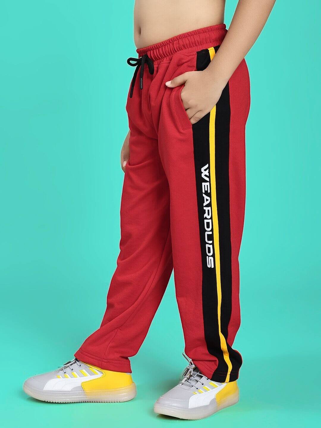 Child wearing ROGER RELAXED-FIT JOGGER FOR BOYS AND GIRLS RED BLACK, stylish casual pants with side stripes and pockets.