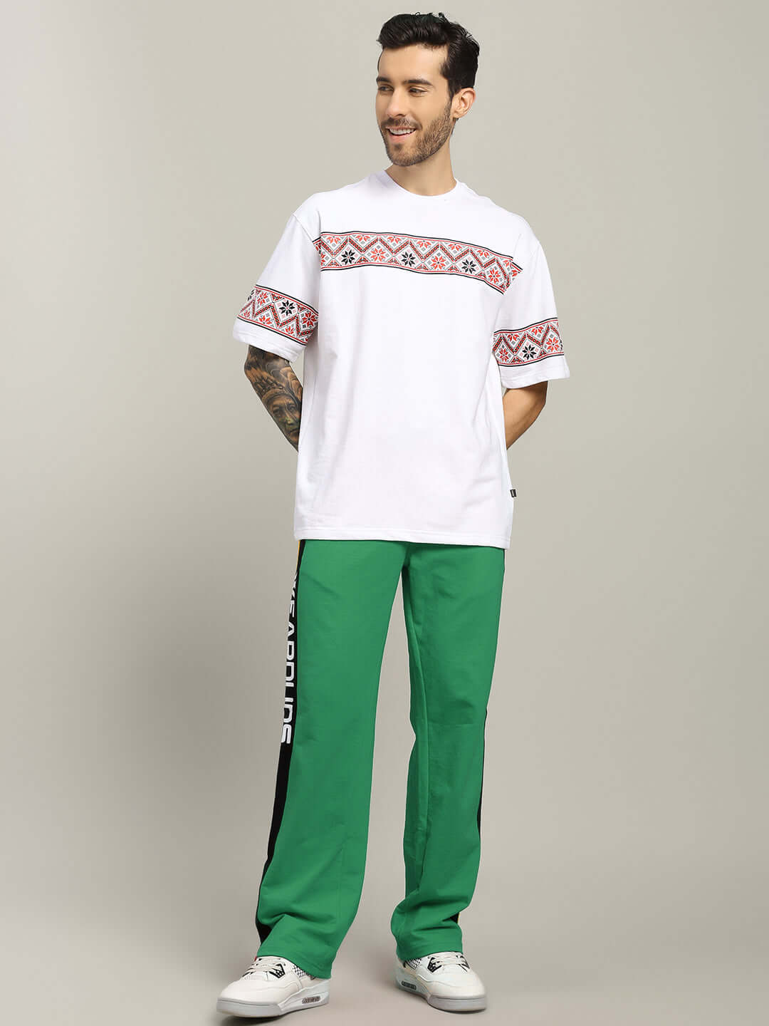 Man wearing ROGER RELAXED-FIT JOGGERS GREEN with white patterned shirt