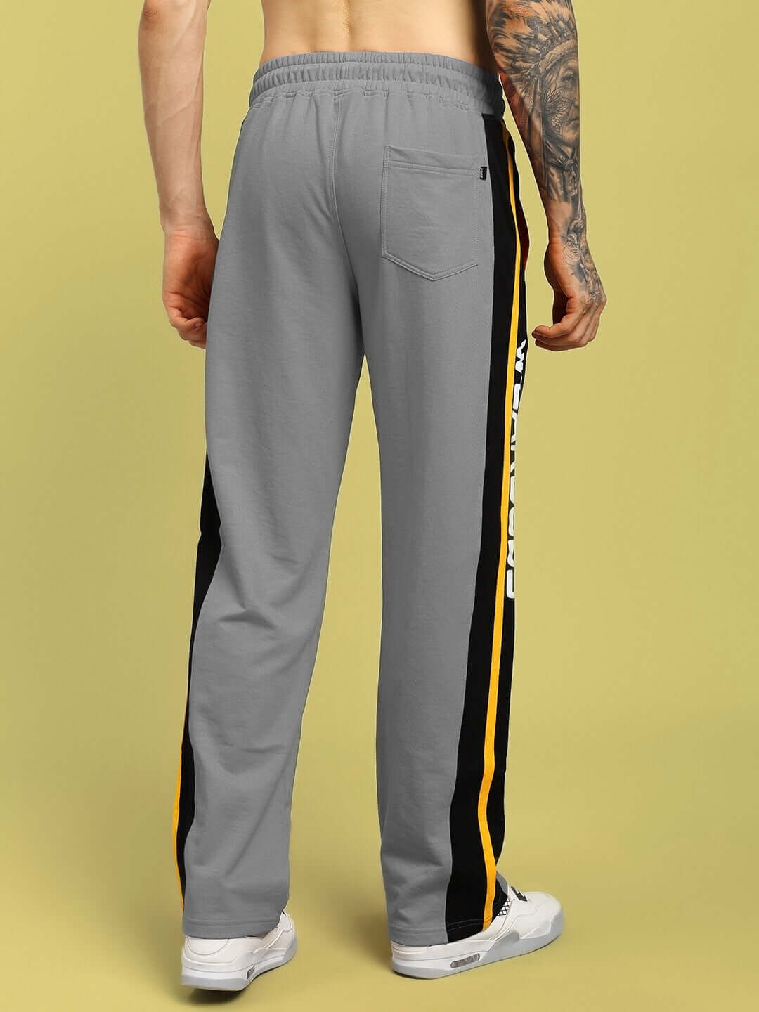 Back view of grey relaxed-fit joggers with stripe detail, designed for comfort and style. Ideal for customized sizing options.