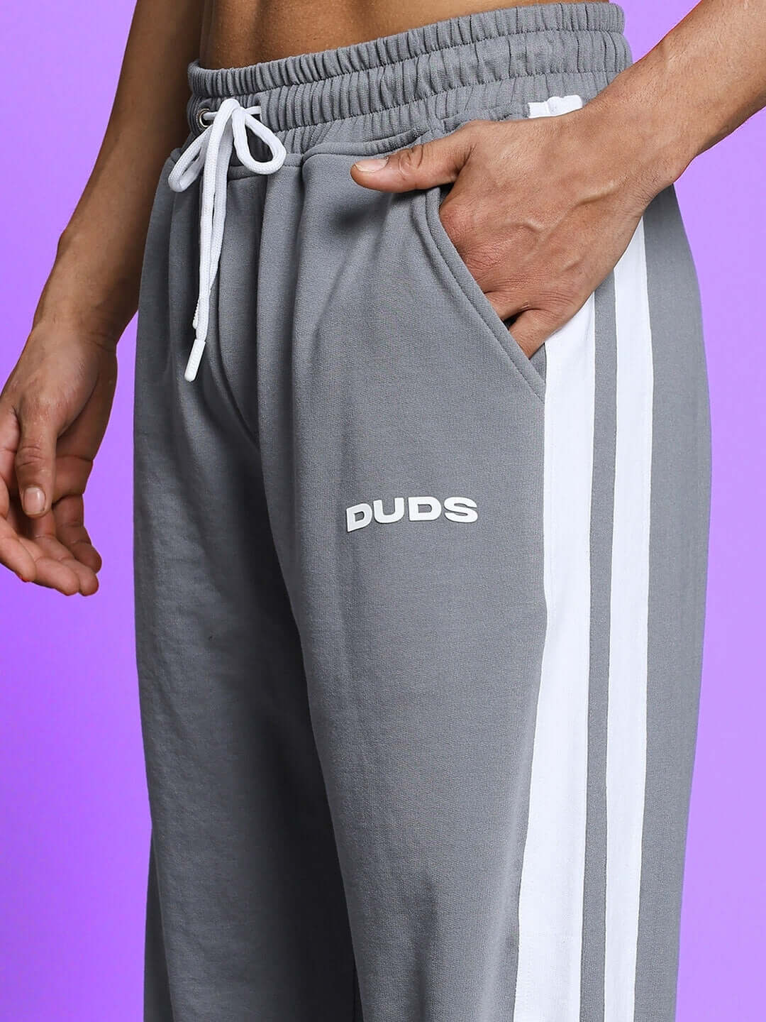 Grey joggers with white side stripes and DUDS logo, showcasing comfortable fit and design, perfect for custom fit option.