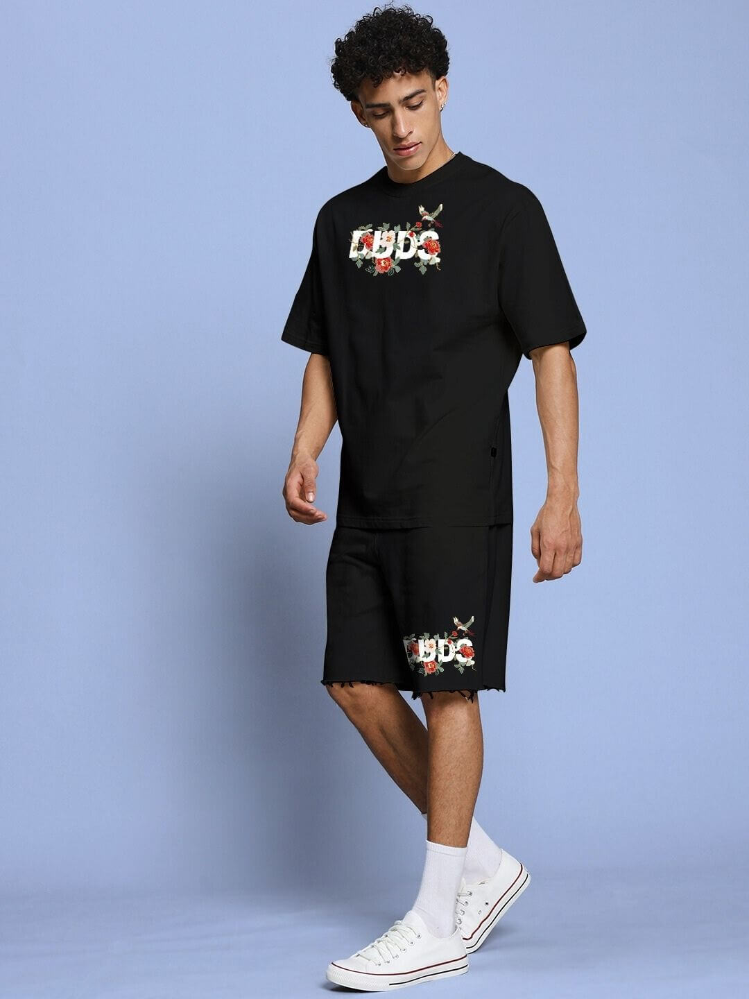 Model wearing ROSE CHARM RELAXED FIT CO-ORD SET BLACK with floral details, featuring casual and comfortable design.