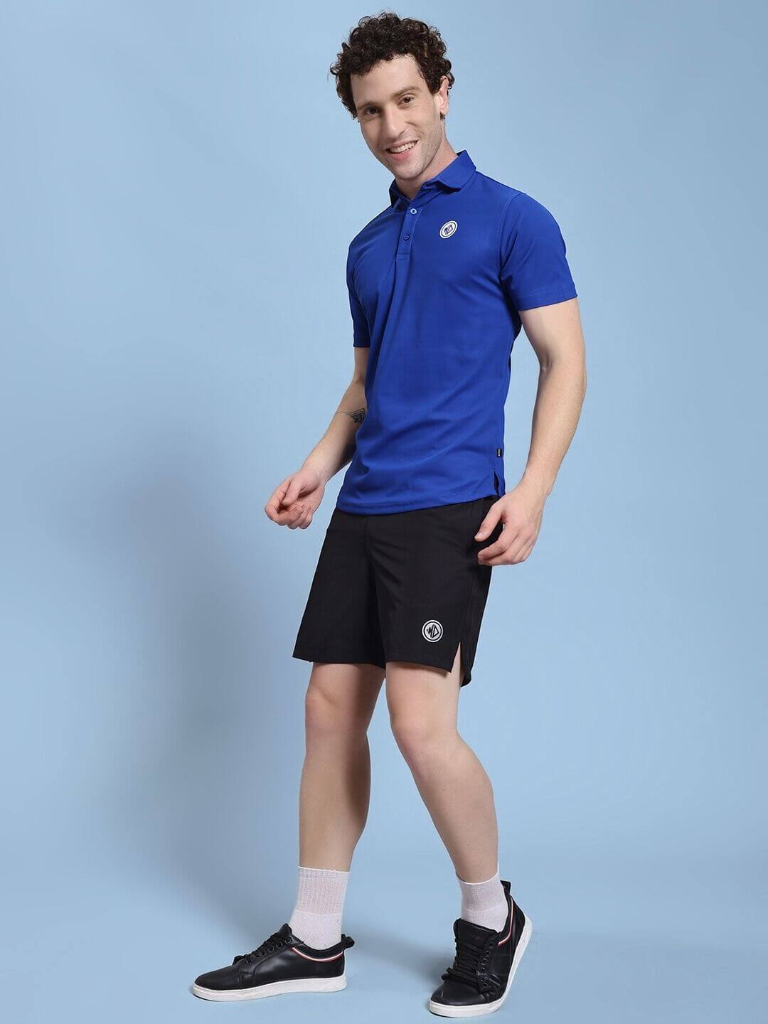 Man wearing ROSEWOOD CO-ORD SET BLUE BLACK, showcasing modern streetwear with a sleek silhouette and bold color blocking.