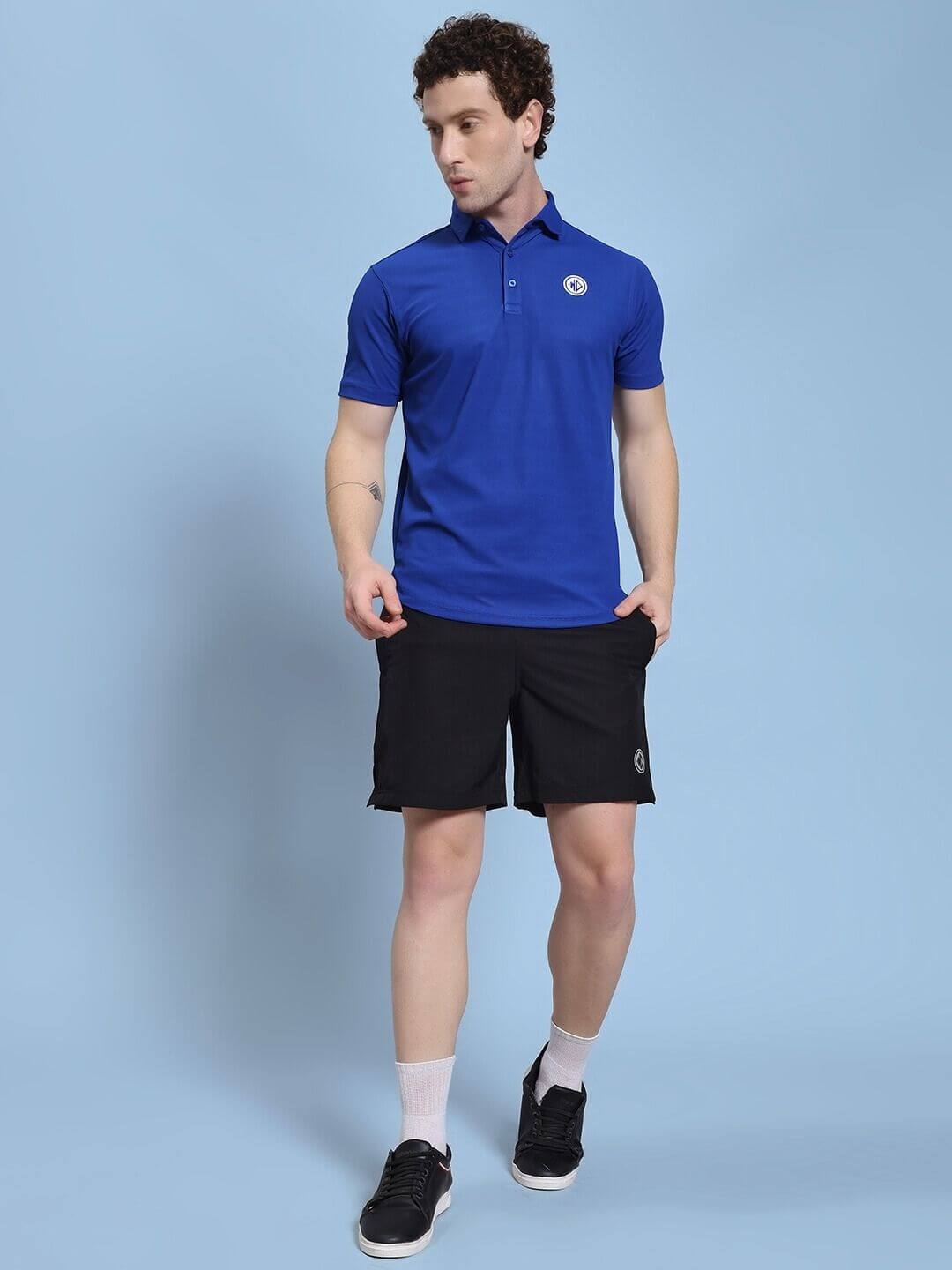 Man wearing ROSEWOOD CO-ORD SET BLUE BLACK with bold color blocking in blue and black, embodying modern streetwear style.