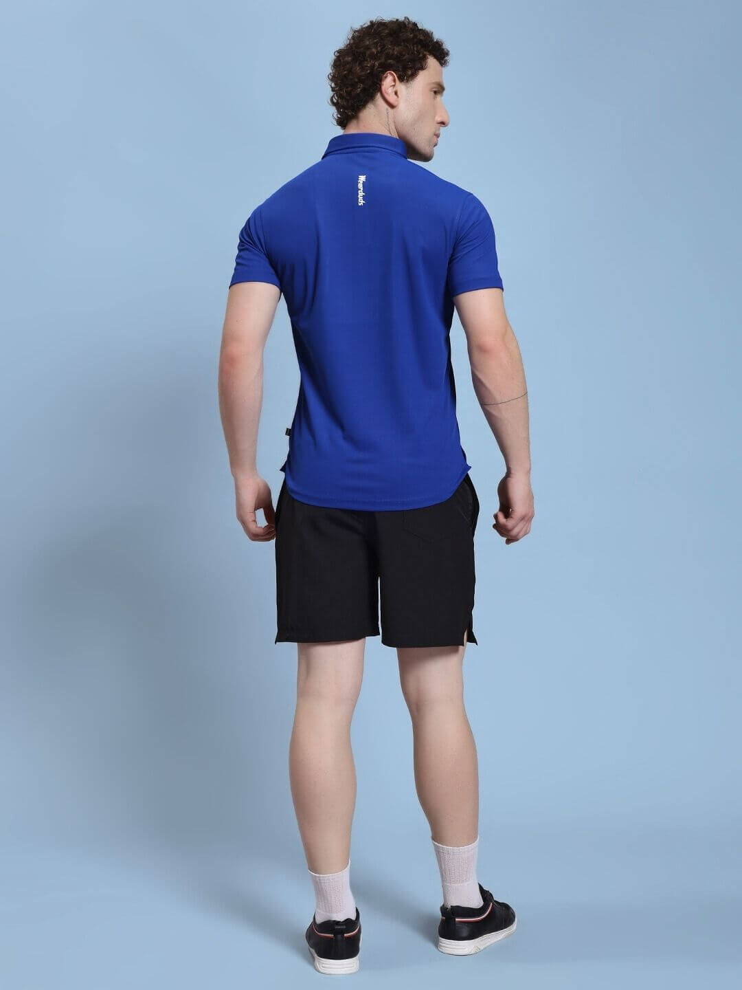 Model wearing the ROSEWOOD CO-ORD SET BLUE BLACK from the back, highlighting the color block design of the modern streetwear ensemble.