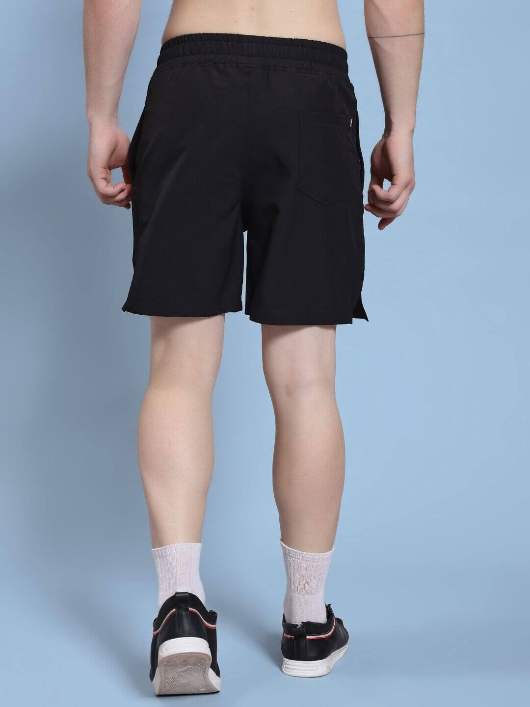 Back view of ROSEWOOD RELAXED FIT SHORTS BLACK highlighting the relaxed silhouette and comfort in movement.