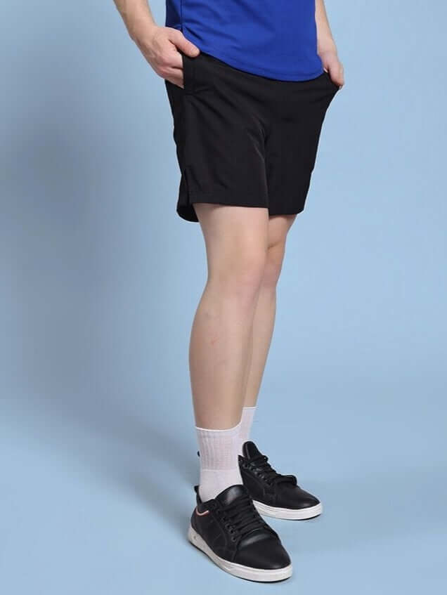 Person wearing ROSEWOOD RELAXED FIT SHORTS BLACK with casual shoes, showcasing comfort and style.