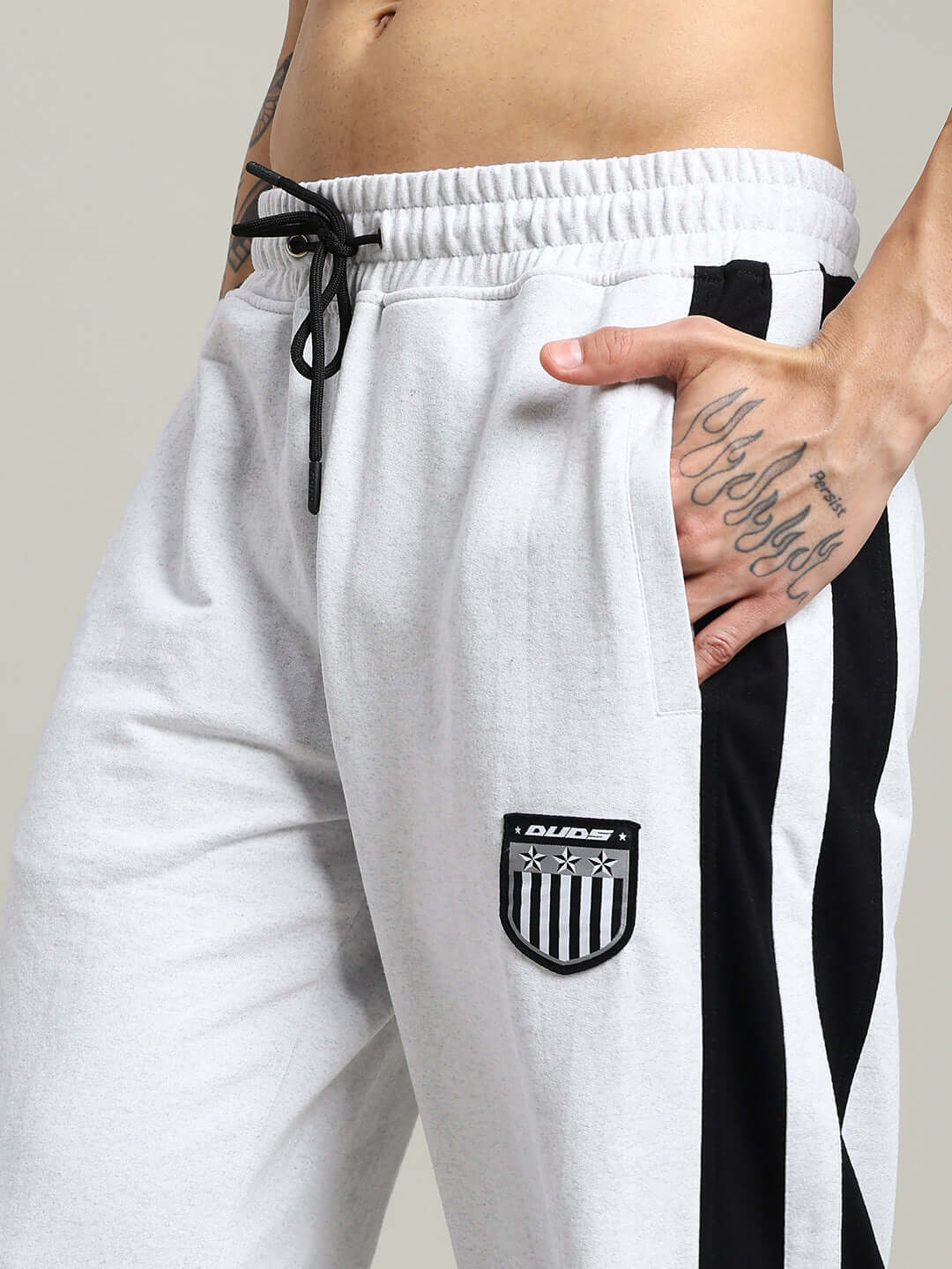 Close-up of ROYALSON COTTON JOGGERS MELANGE-GREY featuring contrast panel design and patch logo, perfect for comfort and style.