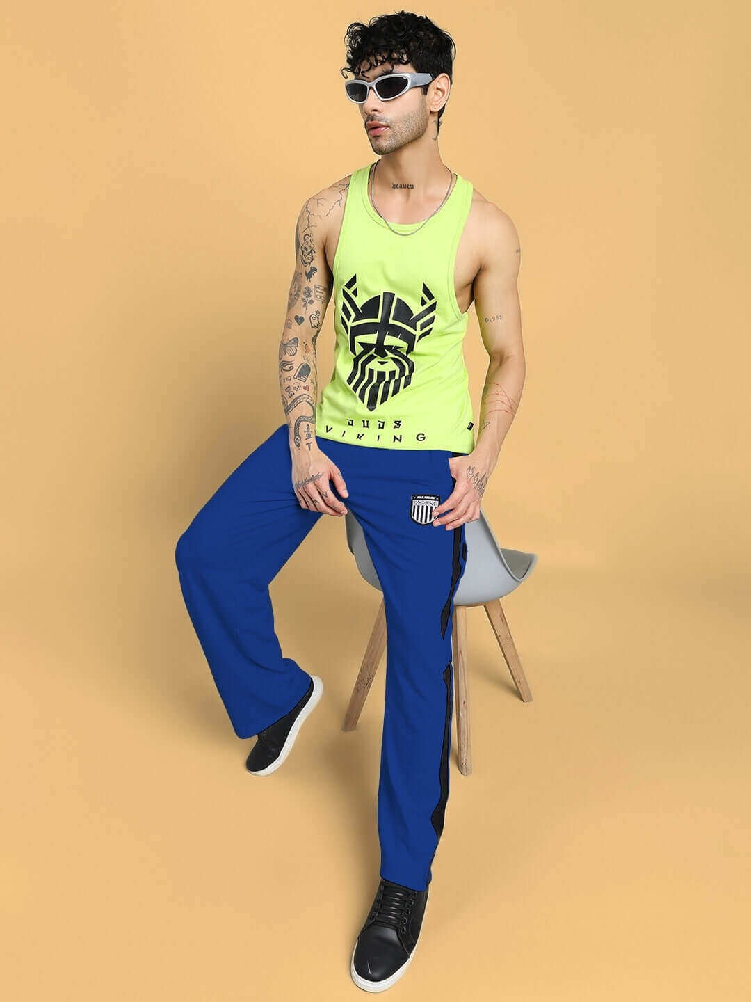 Model wearing ROYALSON PREMIUM JOGGERS IN BLUE with a neon tank top against a neutral background.