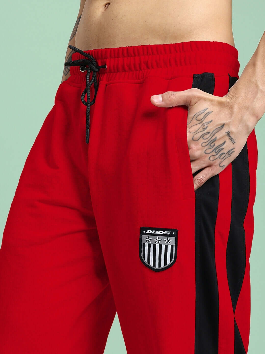 Model wearing Royalson Premium Joggers in vibrant red, showcasing premium construction and bold design for confident individuals.