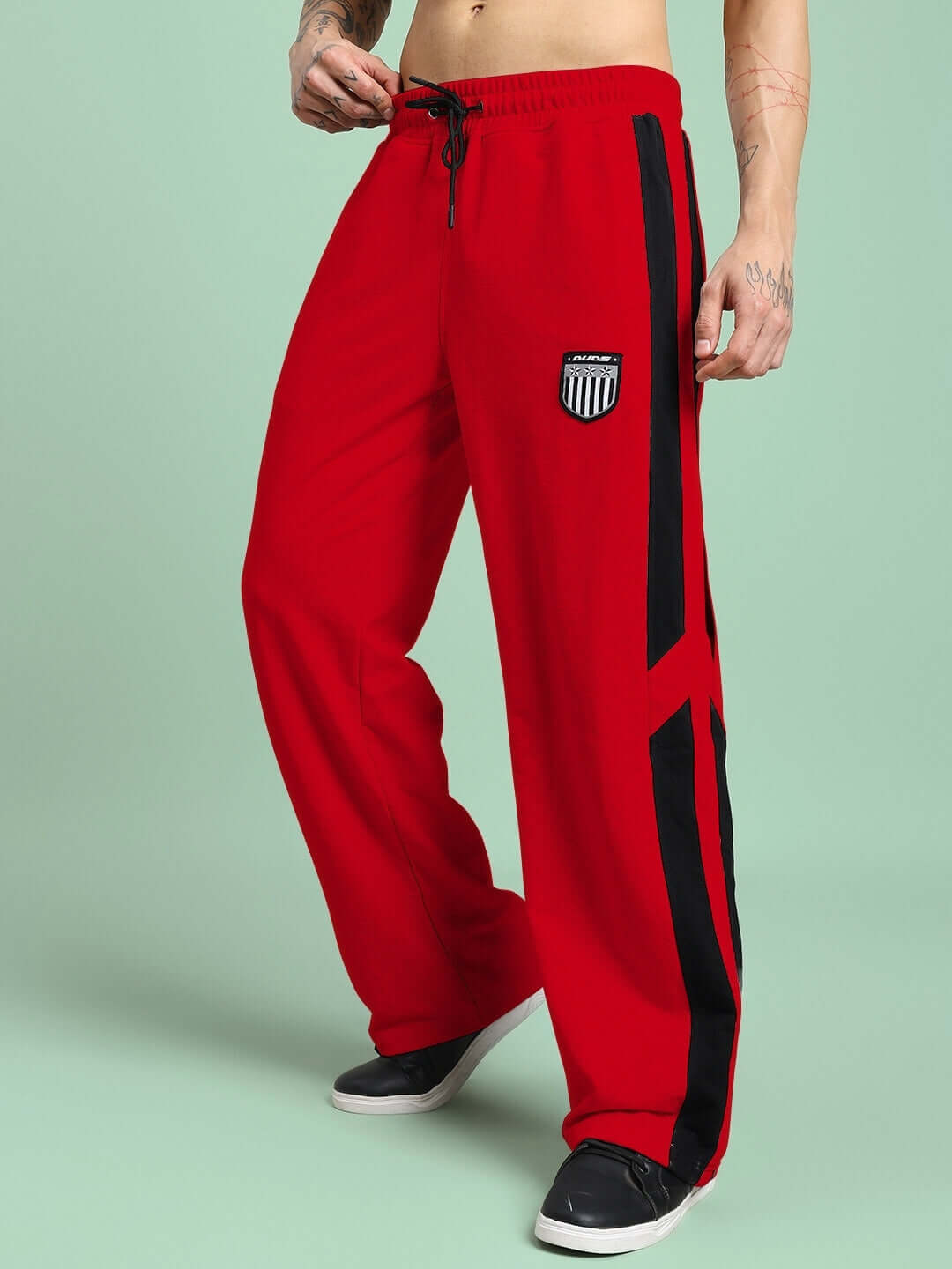 Person wearing ROYALSON PREMIUM JOGGERS IN RED, showcasing vibrant color and sleek design against a light background.