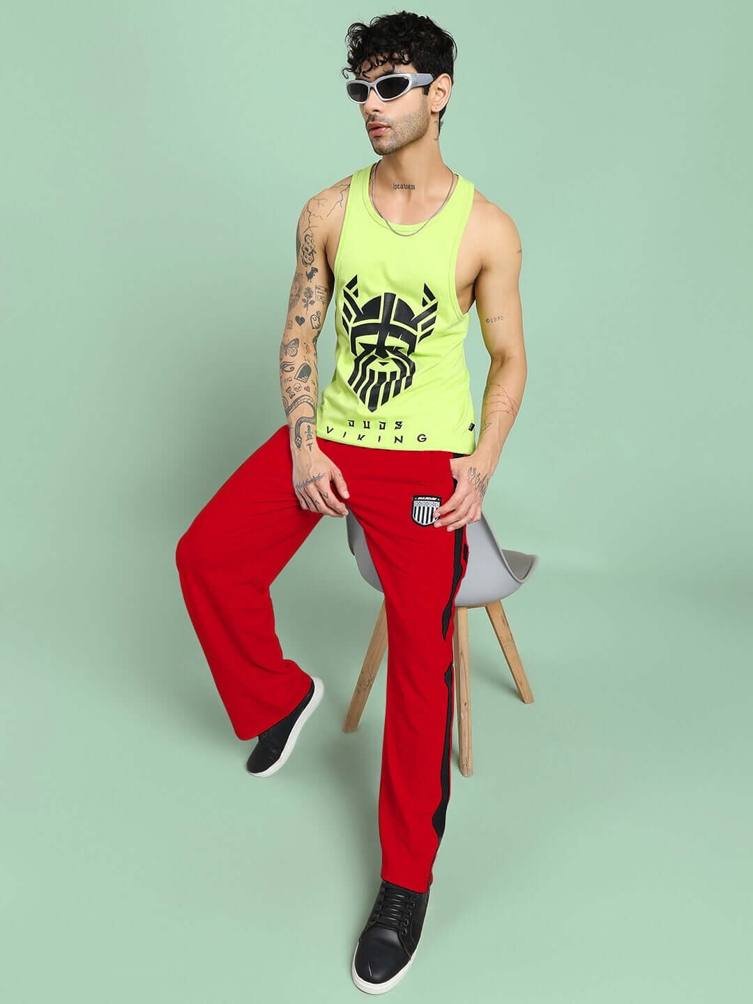 Man wearing ROYALSON PREMIUM JOGGERS IN RED with stylish tank top, showcasing bold and high-quality activewear.