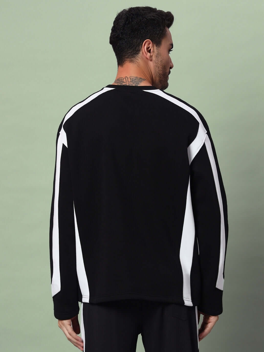 Back view of RUGBY OVERSIZED FLEECE SWEATSHIRT BLACK with white stripes, displaying its relaxed fit and modern streetwear style.