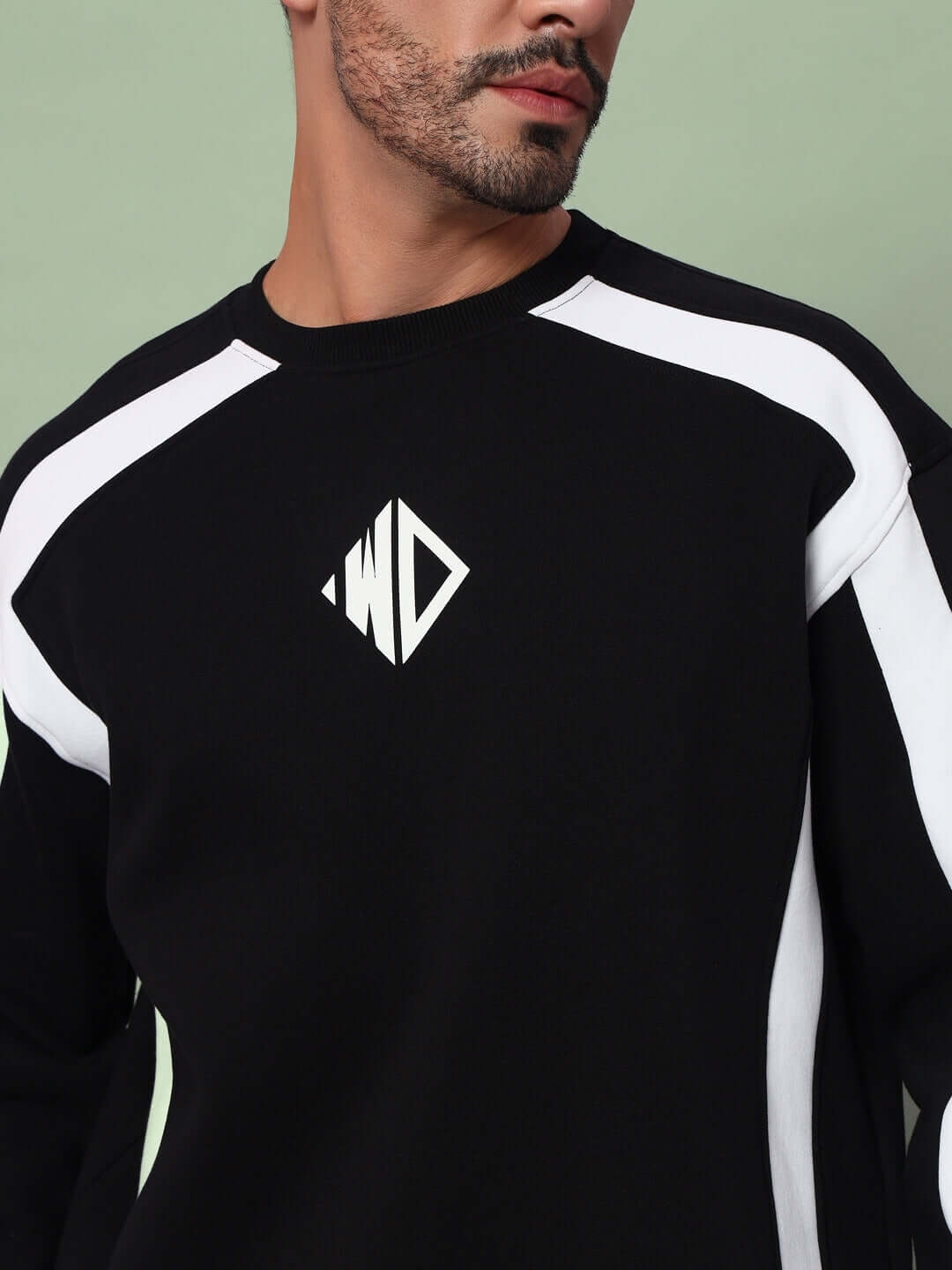 Person wearing RUGBY OVERSIZED FLEECE SWEATSHIRT BLACK with white accents and logo.