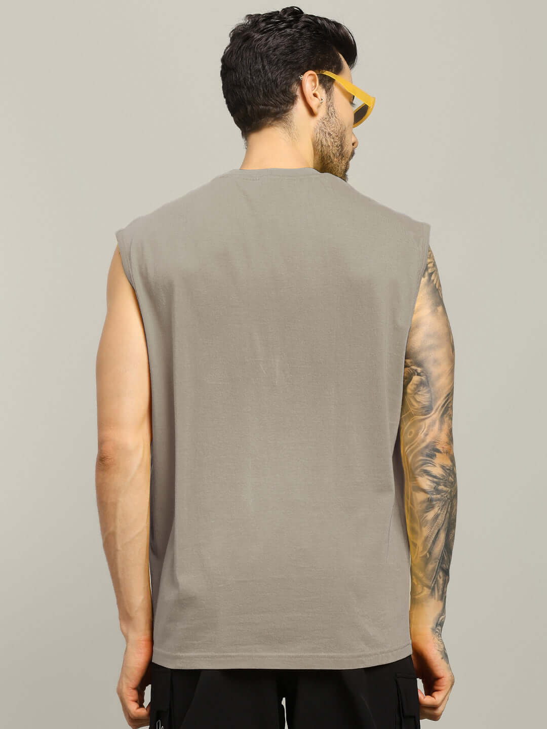 Back view of a man wearing a grey Ryujin Kai printed gym T-shirt showcasing fitness style.