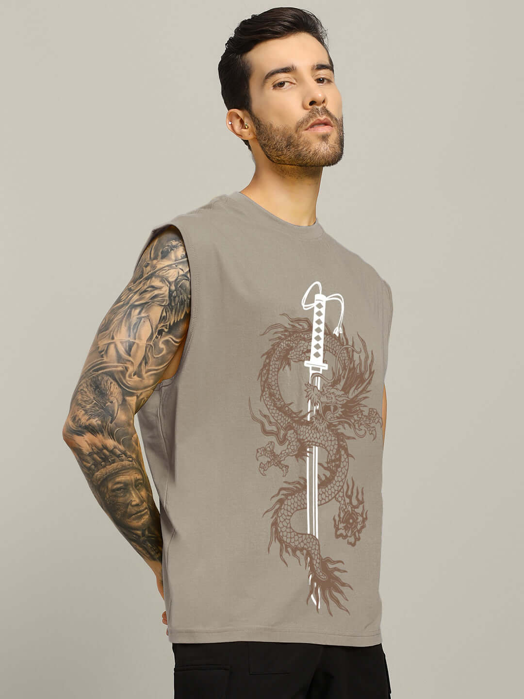 Man wearing grey sleeveless Ryujin Kai gym T-shirt with dragon print, showing tattooed arm.