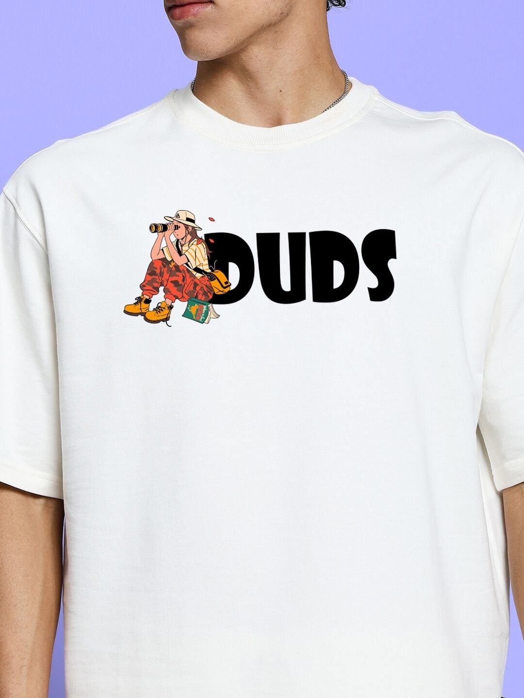 Close-up of a person wearing the SAFARI PRINTED CO-ORD SET OFF-WHITE featuring safari-inspired graphics on a white tee.