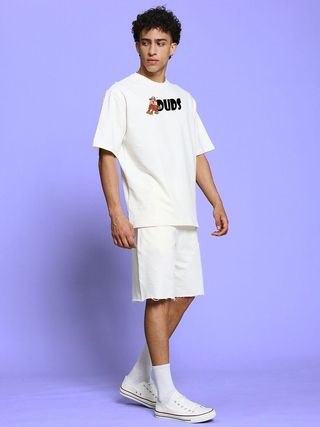 Model wearing SAFARI PRINTED CO-ORD SET OFF-WHITE with safari-inspired design on a purple background.