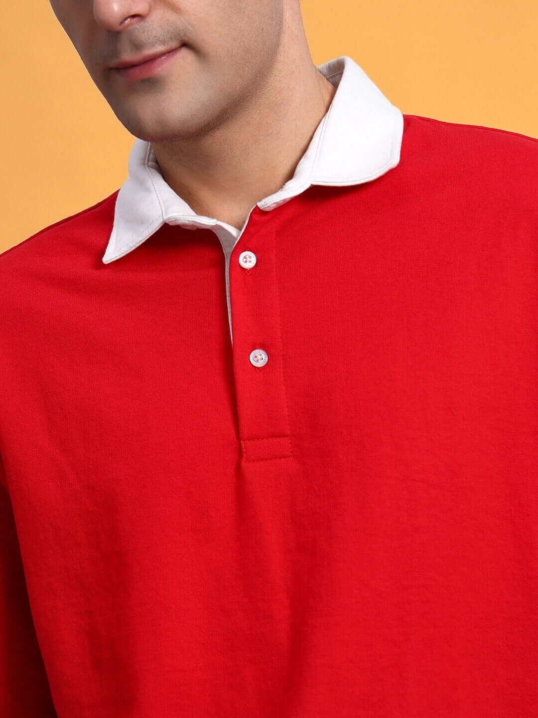 Person wearing red SAGOL Polo Oversized Sweatshirt with white collar, made of premium cotton French Terry Lycra, from India.