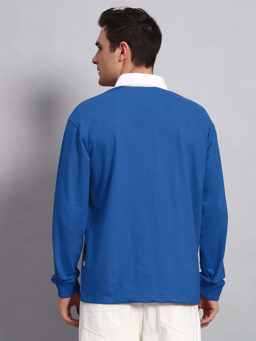 Model wearing SAGOL Polo Oversized Sweatshirt in Royal Blue, made from premium cotton French terry fabric, showcasing back view.