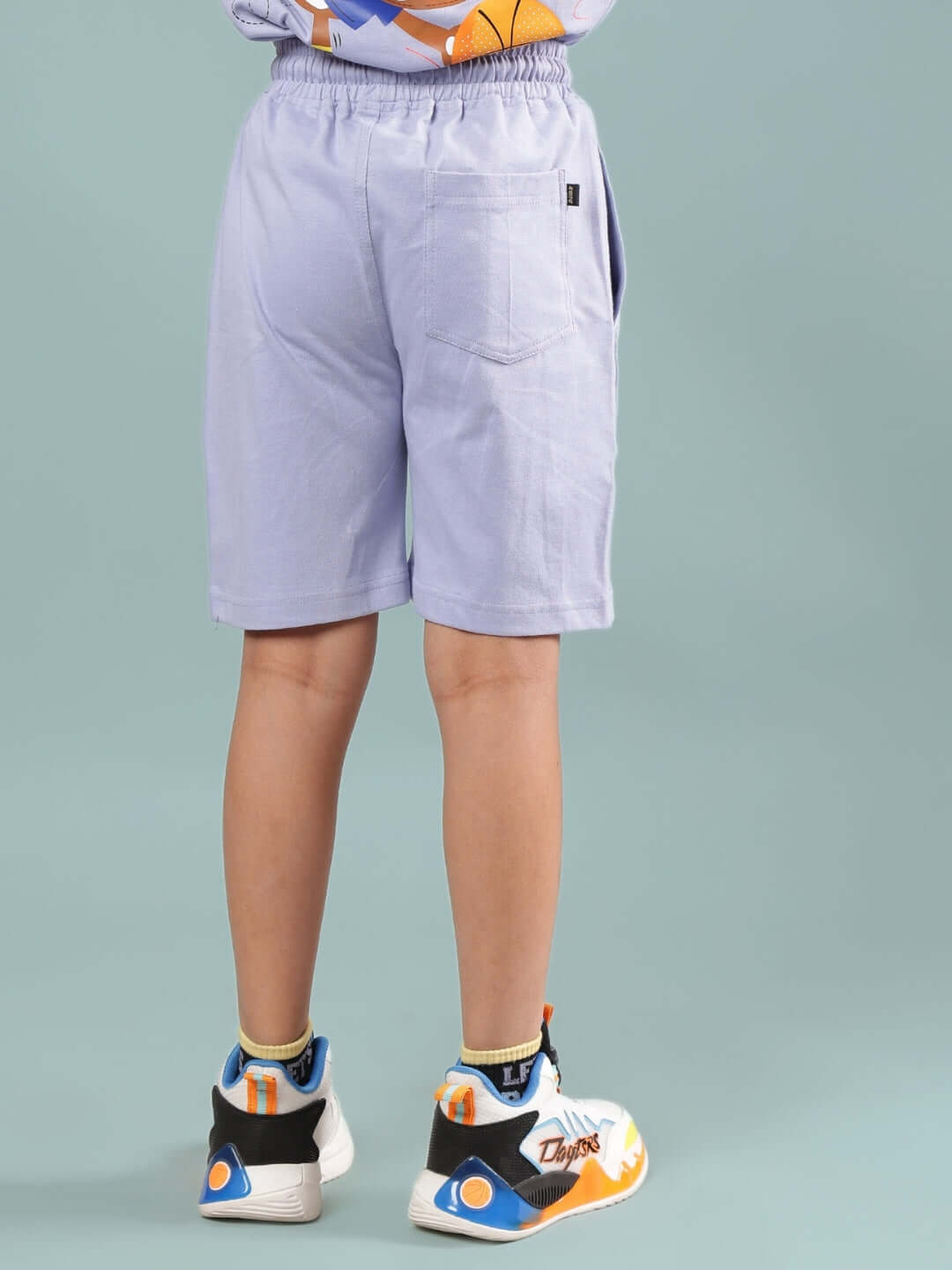 Child wearing SAMMY SHORTS FOR BOYS & GIRLS LAVENDER, showcasing back detail, comfortable fit, suitable for both genders.