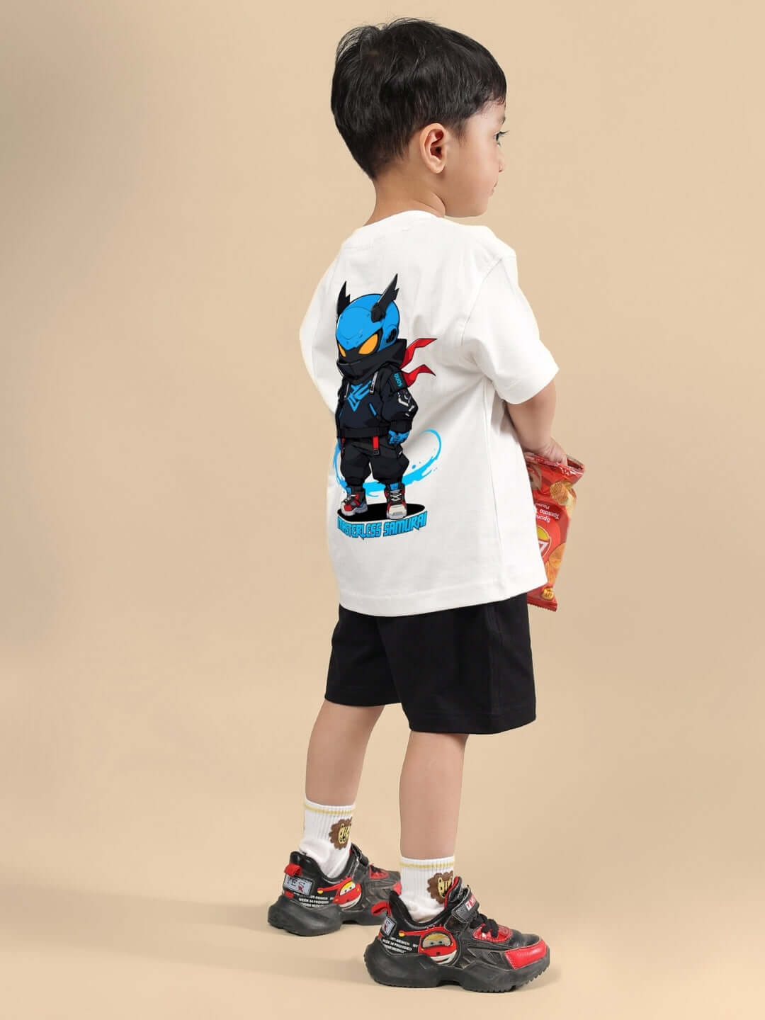 Boy wearing SAMURAI PRINTED CO-ORD FOR BOYS & GIRLS OFF WHITE BLACK outfit, showcasing the back design with samurai print.