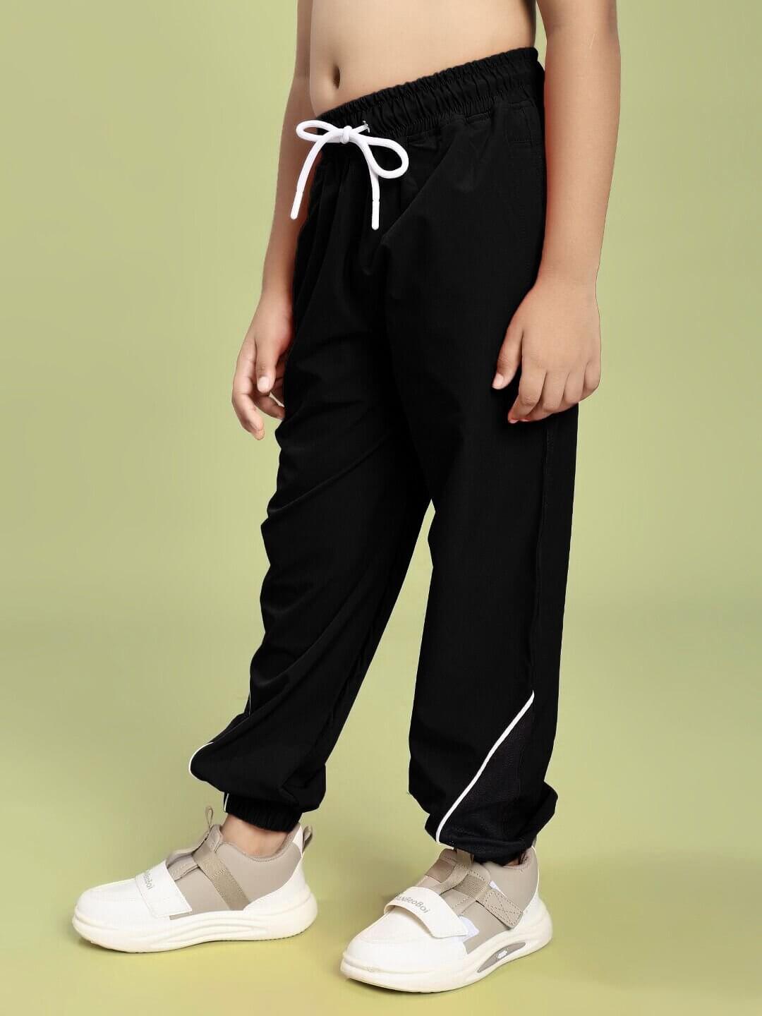 Child wearing SAMURAI SOUL PRINTED CO-ORD FOR BOYS AND GIRLS WHITE BLACK with drawstring pants and sneakers.
