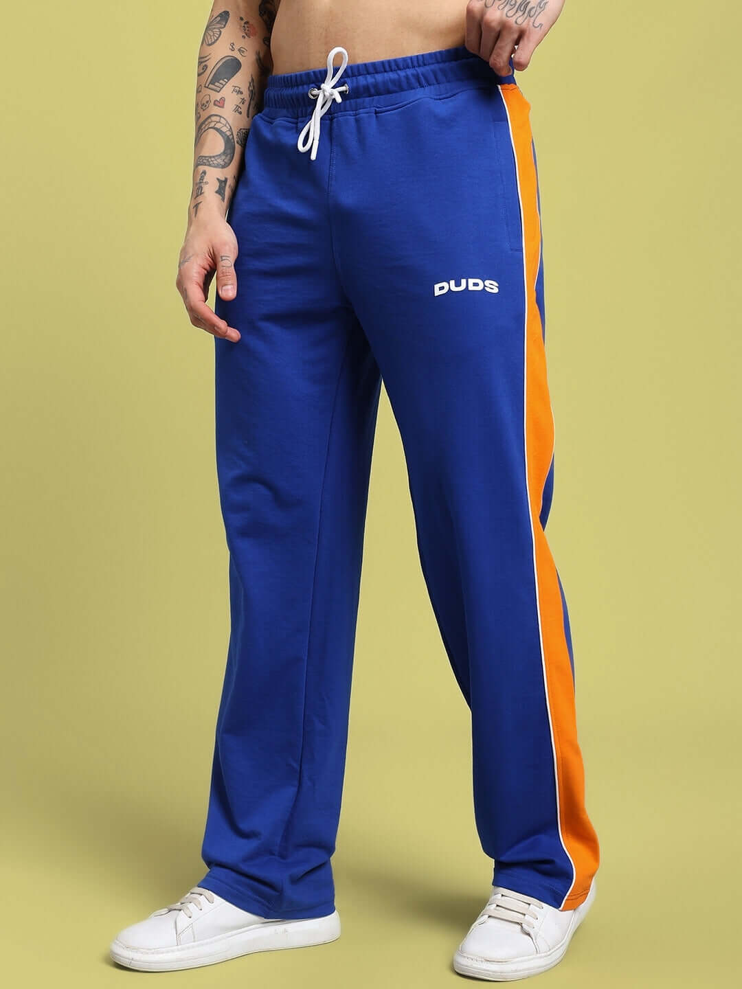 Person wearing SANFORD STRIPE JOGGERS BLUE with orange stripe, perfect for fitness enthusiasts. Casual, sporty style jogging pants.