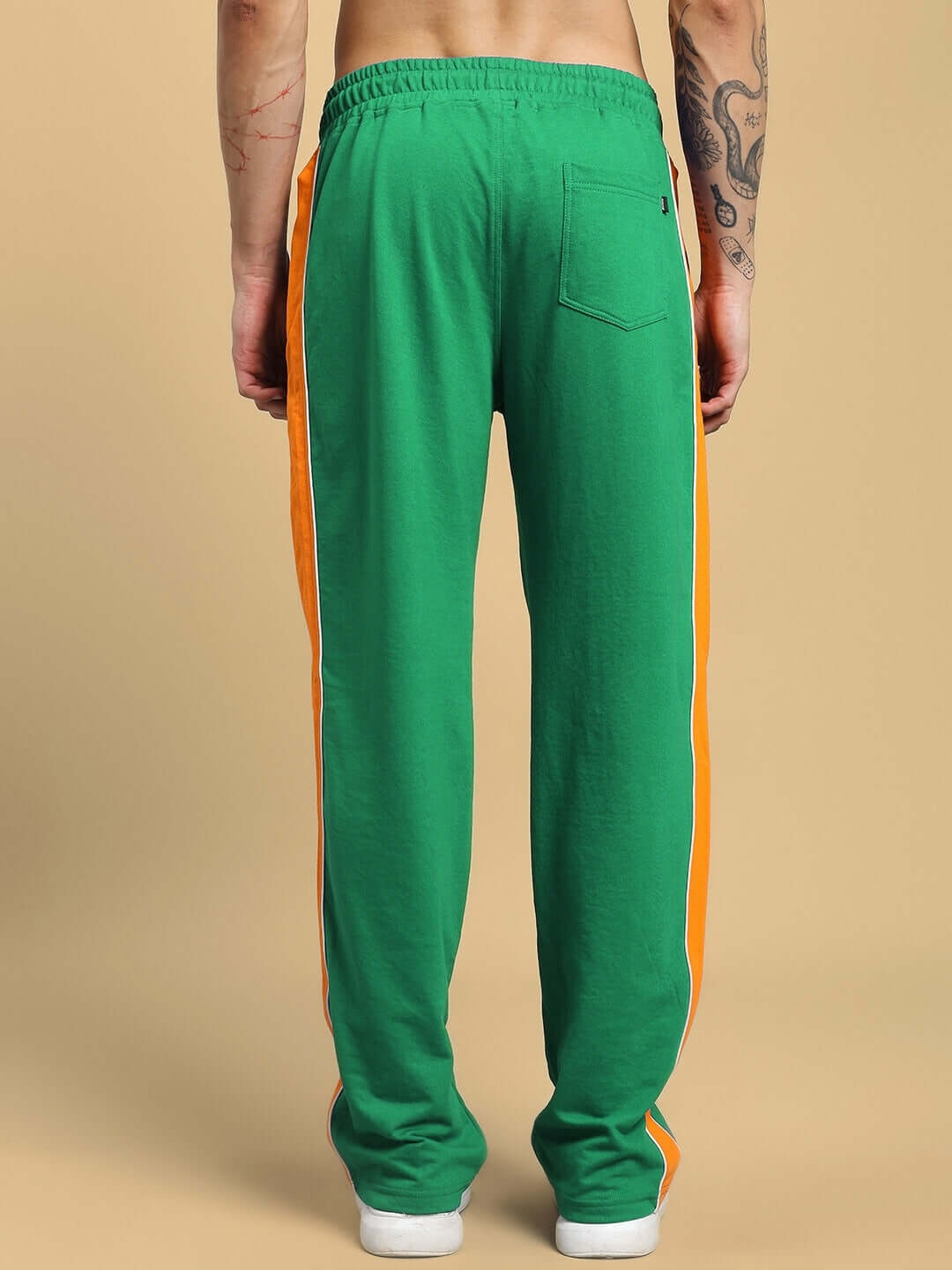 Back view of SANFORD STRIPE JOGGERS IN GREEN with orange side stripes, showcasing sporty athleisure style perfect for casual outings.