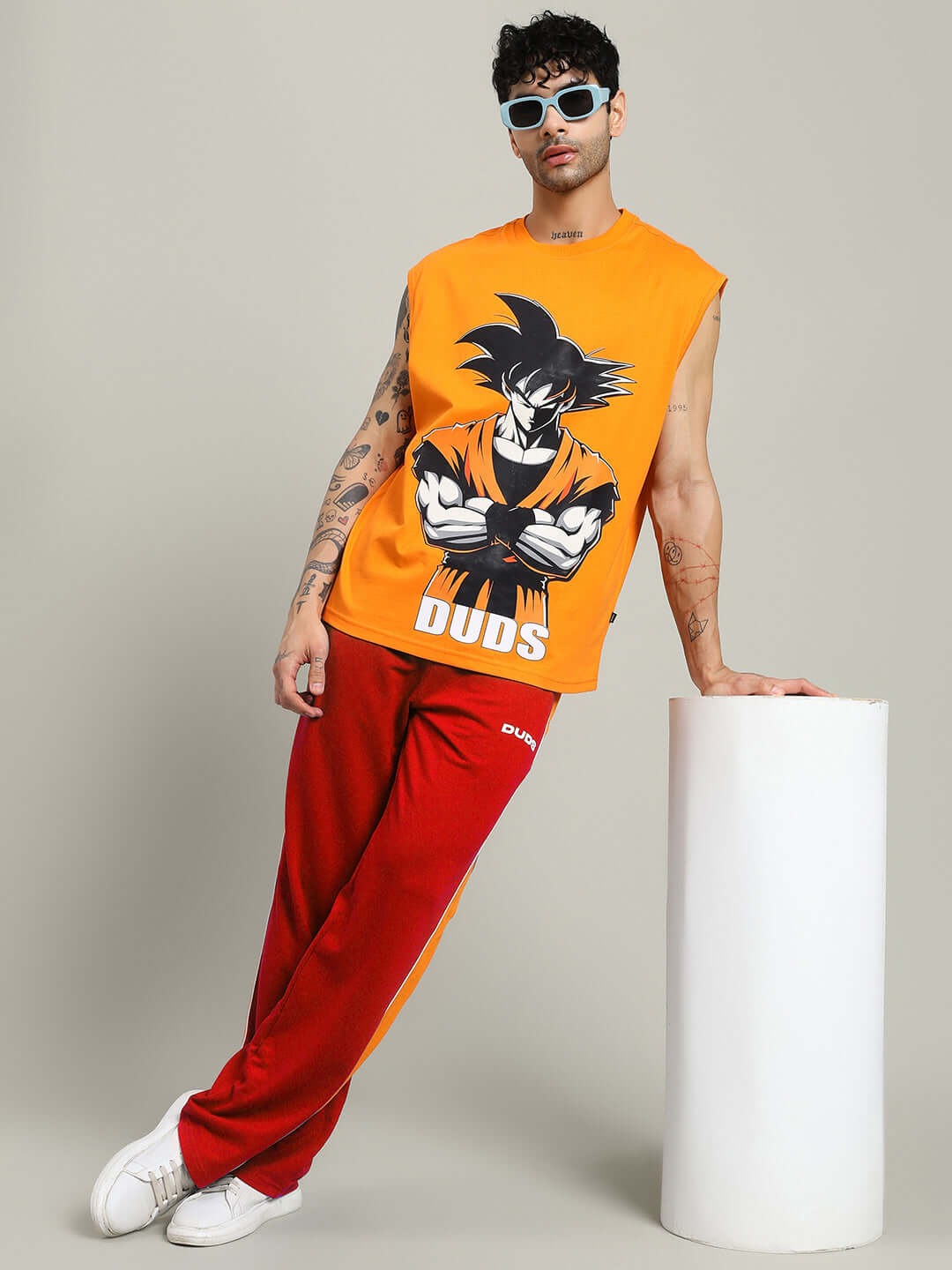 Model wearing SANFORD STRIPE JOGGERS IN RED COLOUR with a bold anime print top, showcasing streetwear style and comfort.