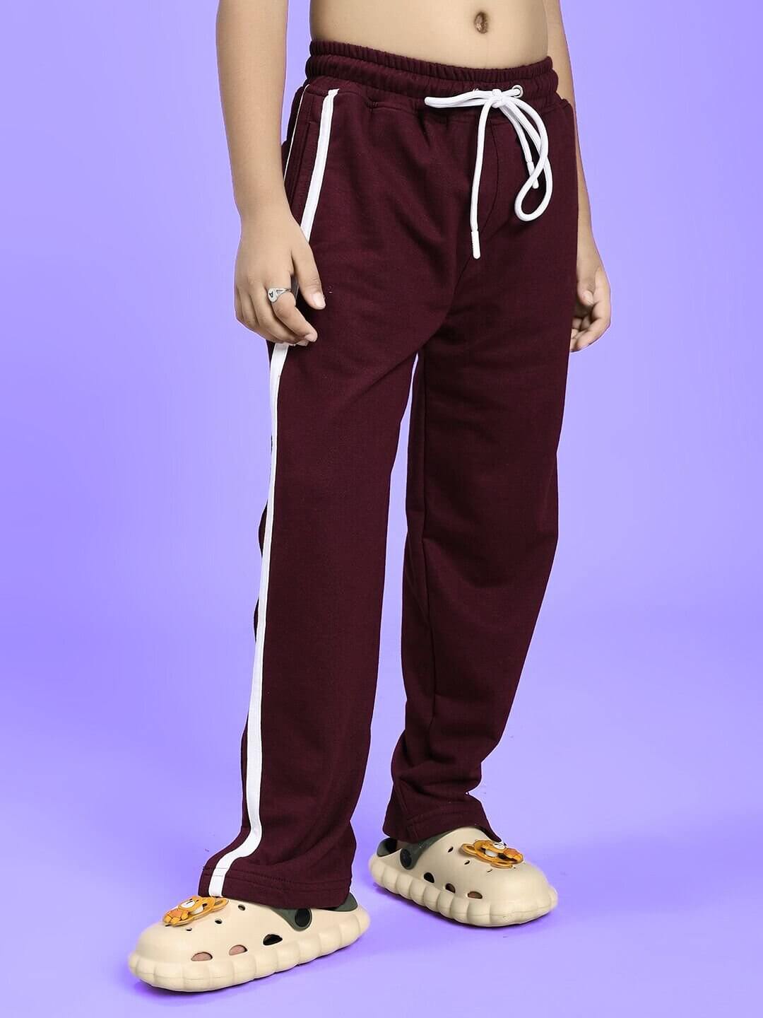 Child wearing SCHOOL DAYS CO-ORD FOR BOYS GIRLS MAROON set with trendy maroon pants and playful shoes, perfect for stylish kids' outfit.