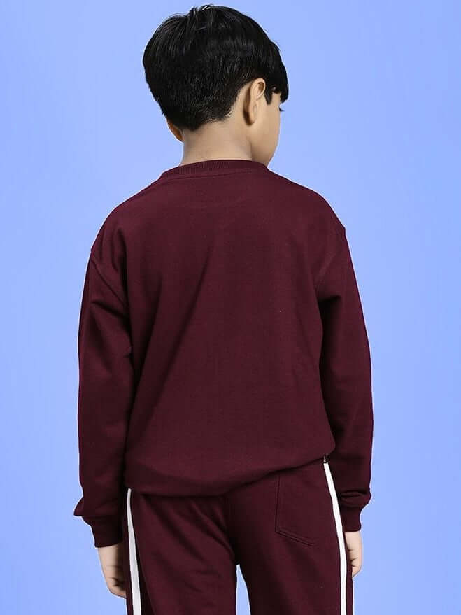 Back view of child wearing SCHOOL DAYS SWEATSHIRT FOR BOYS AND GIRLS MAROON against a blue background.