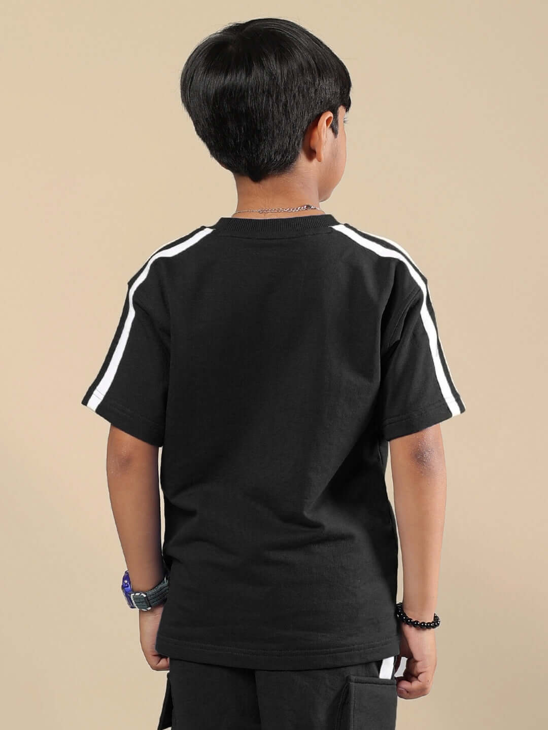 Boy wearing SCOTIA T-SHIRT FOR BOYS & GIRLS BLACK with white striped sleeves