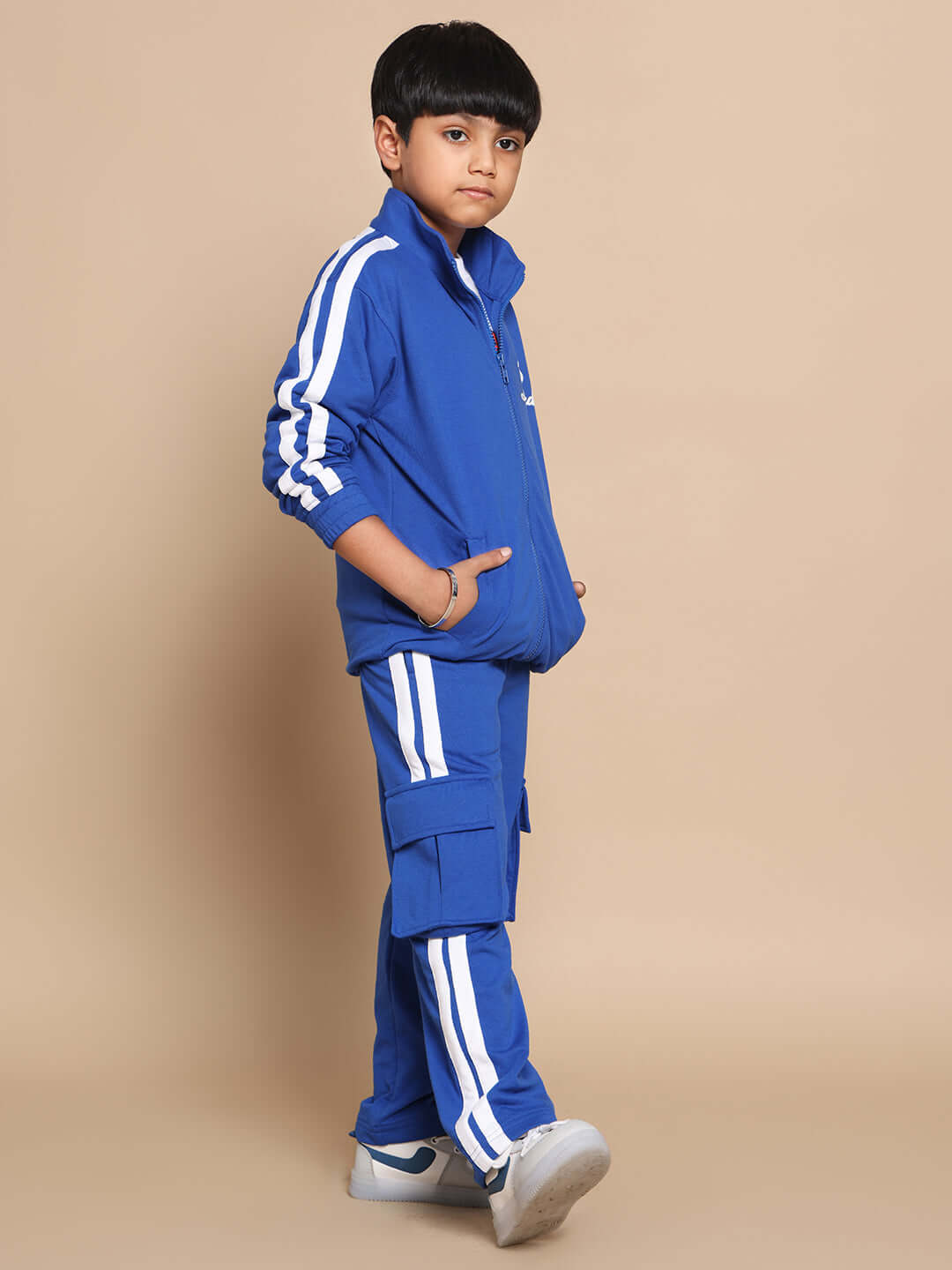 Child wearing Scotia Co-Ord Set in Royal Blue, featuring premium heavy gauge 100% cotton fabric with sporty stripes, posing confidently.