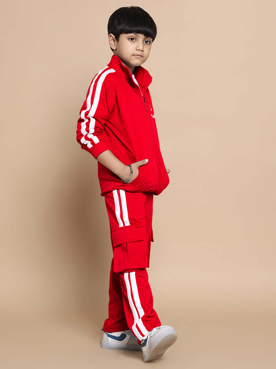 Child wearing red SCOTIA co-ord set with white stripes, 100% cotton terry fabric, ideal for boys and girls, stylish and comfortable.