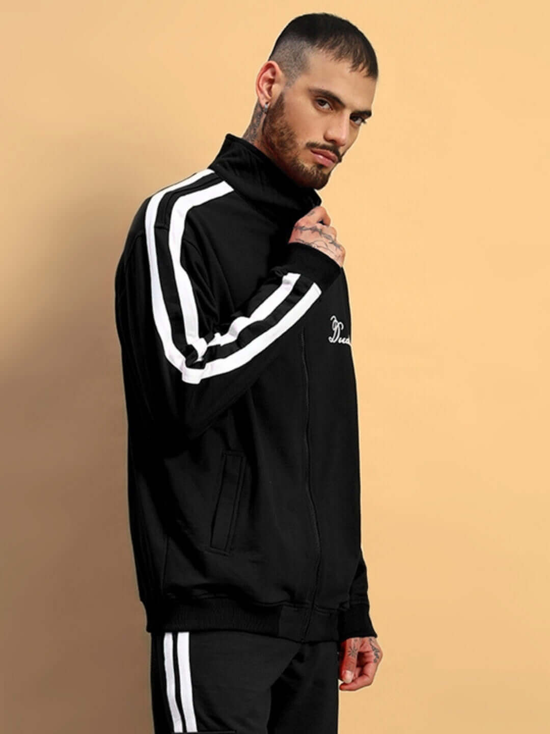 Man wearing a black SCOTIA jacket with white stripes, showcasing a stylish and customizable fit from DUDS.