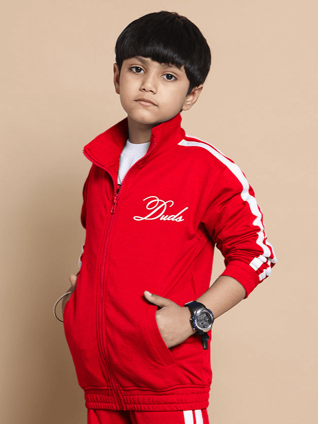 Child wearing red SCOTIA jacket with DUDS logo, suitable for boys and girls, stylish and comfortable outerwear.